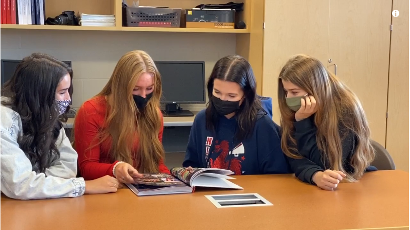 Winning yearbook students from Niles McKinley High School review the yearbook which helped them place third in a national competition